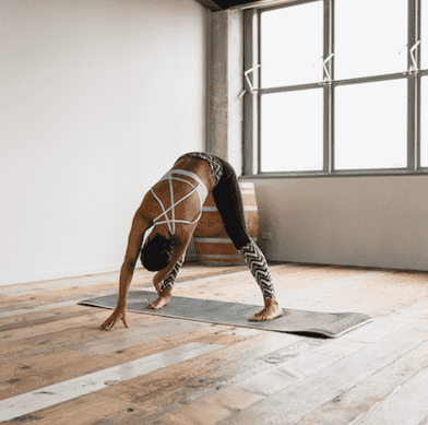 Woman doing yoga pose in yoga studio Woman doing yoga pose in yoga studio