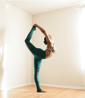 Woman stretching with leg over head Woman stretching with leg over head