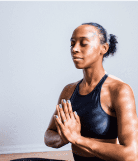 Woman in athletic gear meditating Woman in athletic gear meditating