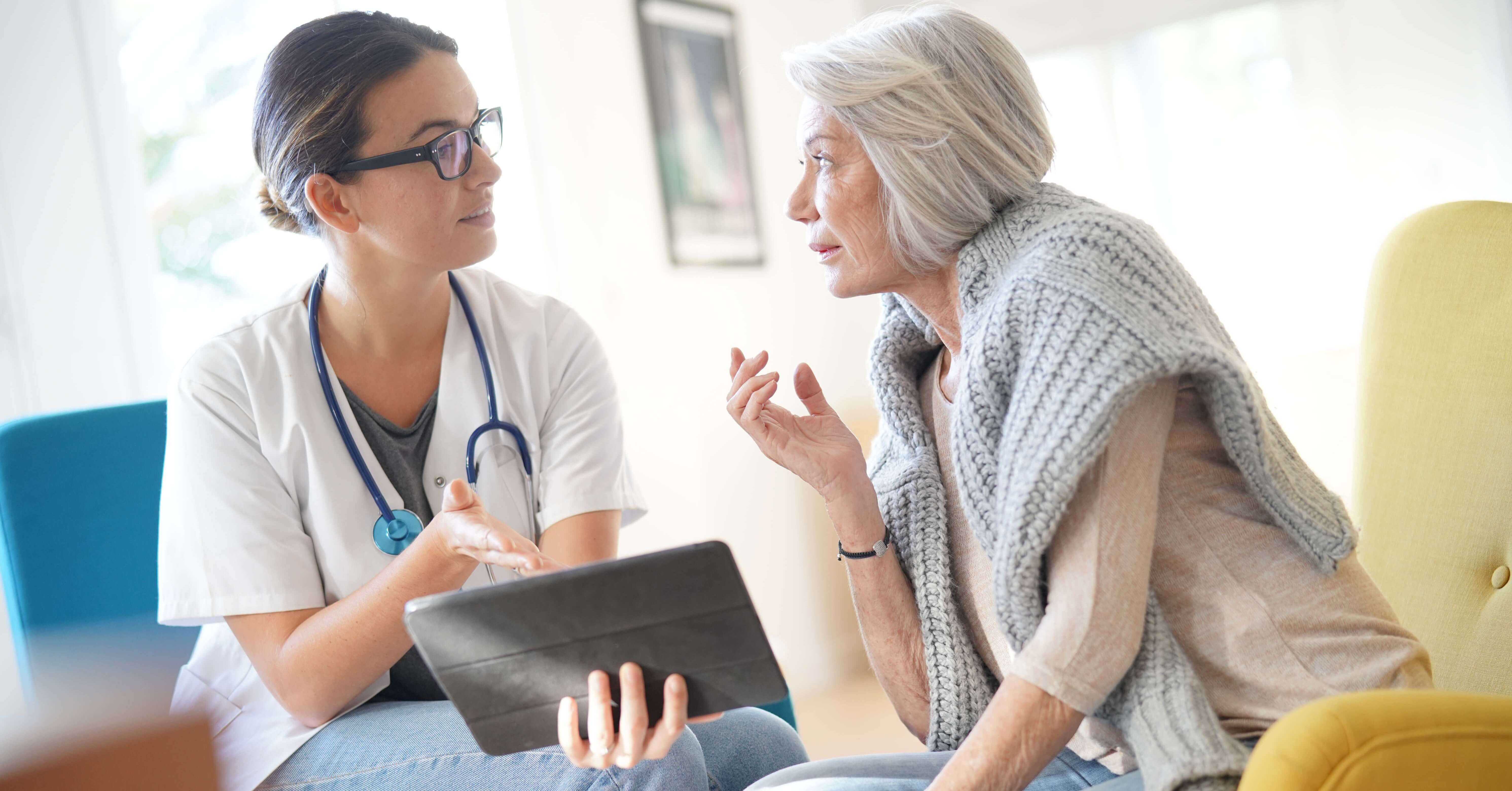 doctor using tablet with patient