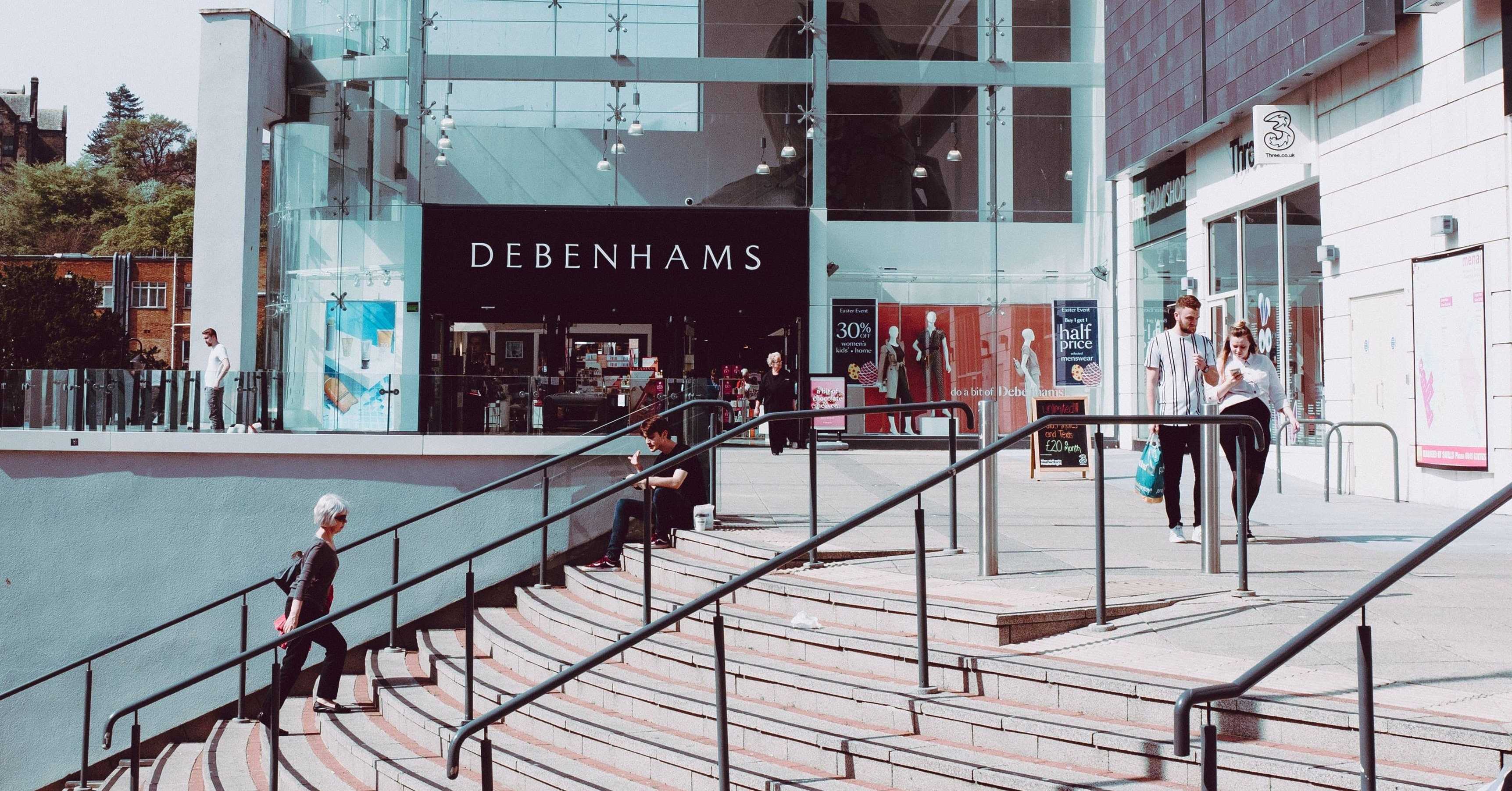 customers on phones outside shopping centre