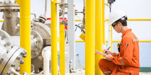 engineer doing inspection of crude oil pump at oil and gas facility