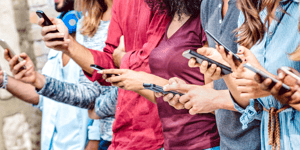 multiple people using their smartphones