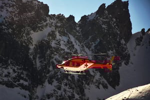 red cross chopper on a rescue mission on the mountains