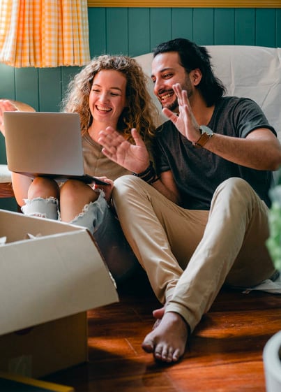 Cheerful couple having video call on laptop