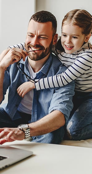 happy father working at computer with his daughter