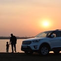 silhouette of man and child near lake