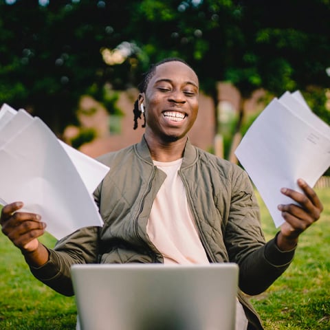 man holding documents laughing
