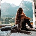 woman in the back of van staring at mountain
