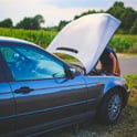 man repairing car
