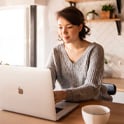 smiling young woman using laptop