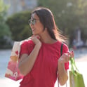 woman in red crew neck t shirt carrying bags
