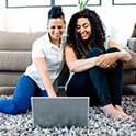 female-couple-looking-at-laptop