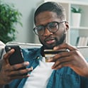 man with phone and debit card