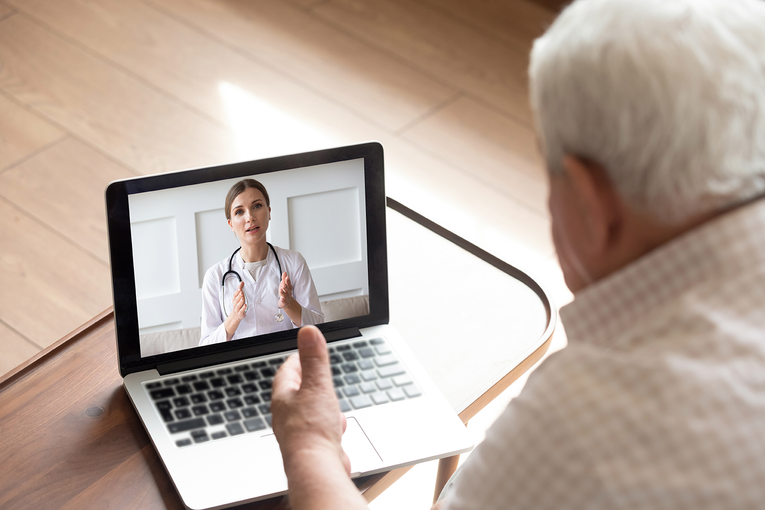man using computer for telehealth visit