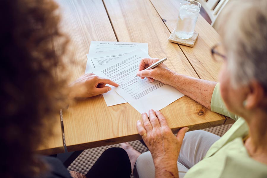 Woman Signing Paperwork 2 - Resized