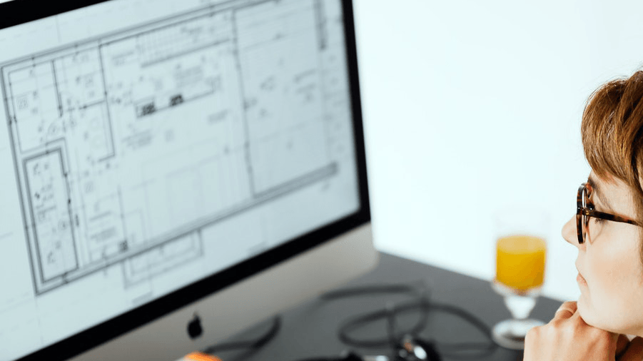 business woman looking at office floorplan