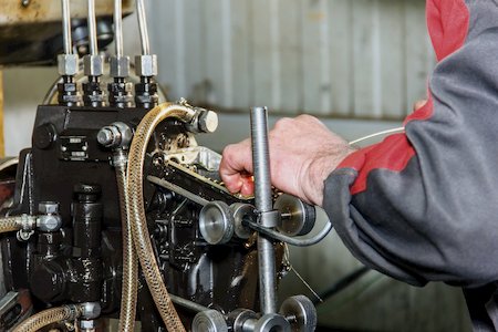 technician working on engine component | Highway & Heavy Parts