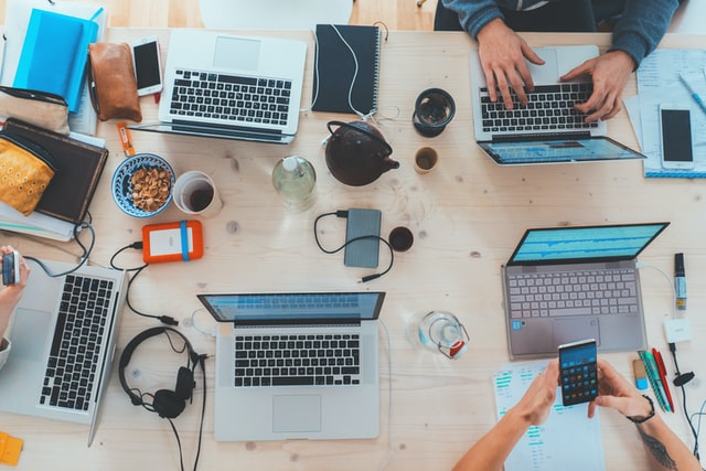 Birds eye view of table with laptops - small