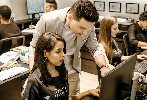 Trainer helping female student - small