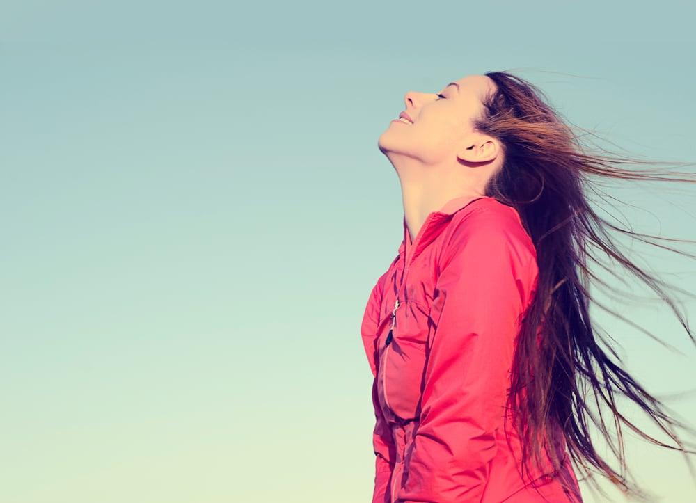 Woman smiling looking up to blue sky taking deep breath celebrating freedom. Positive human emotion face expression feeling life perception success peace mind concept. Free Happy girl enjoying nature