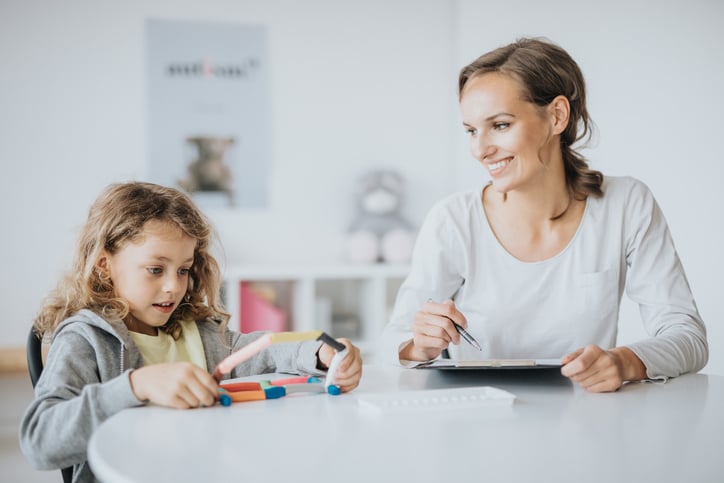 young-child-playing-during-psychotherapy-with-therapist