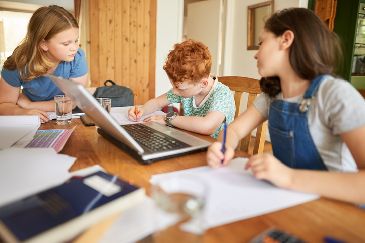 group of kids doing homework together supporting student with autism
