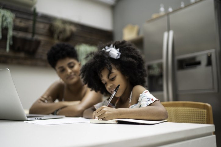 mother helping daughter with autism learn to write