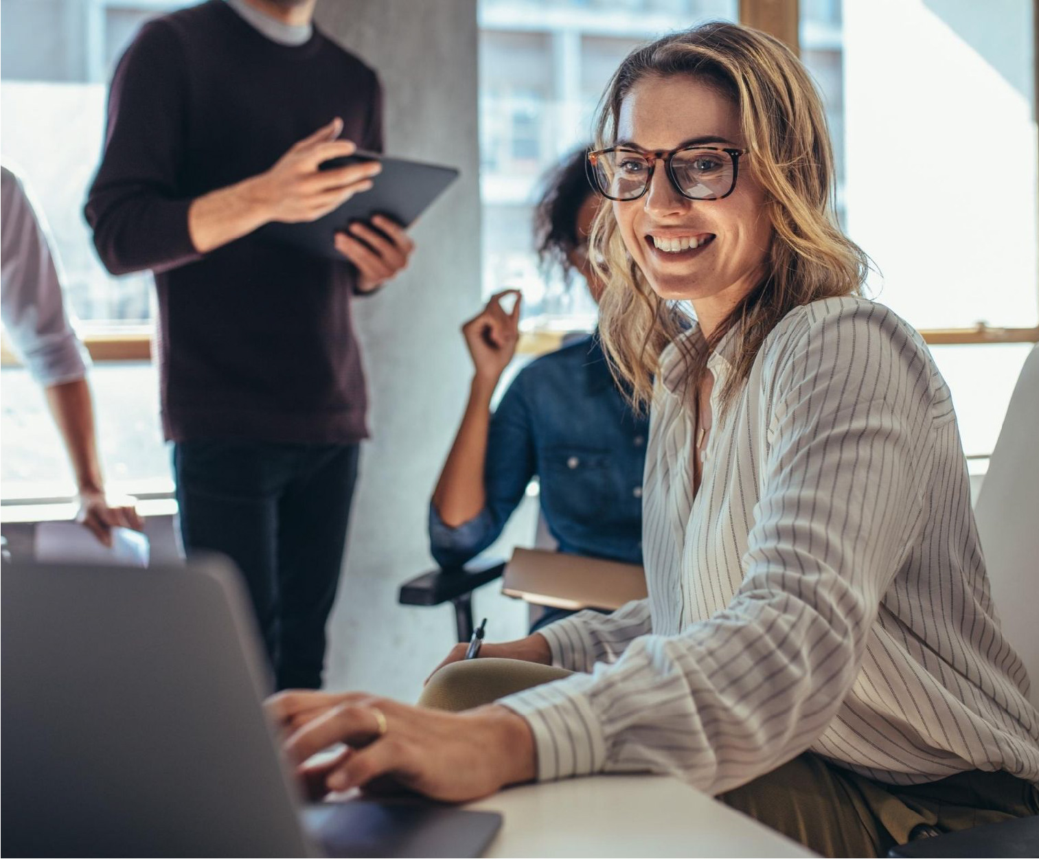Smiling at computer with colleagues-1