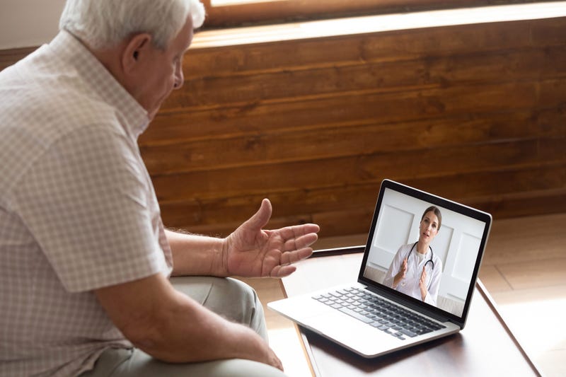 an older man receiving telemedicine help