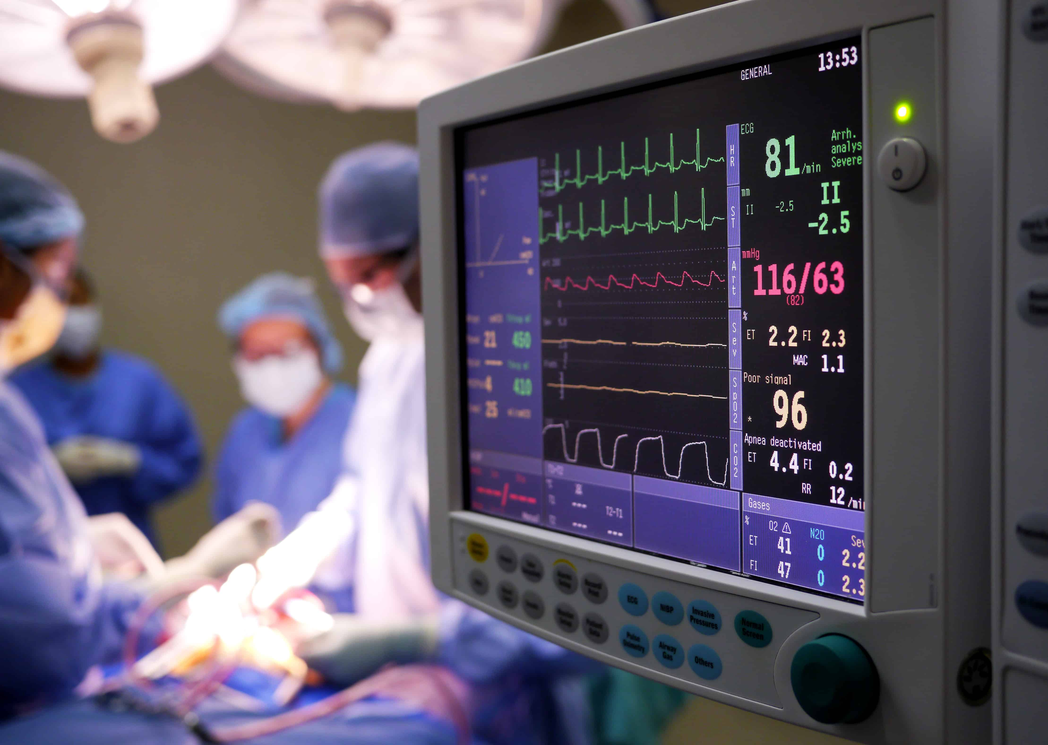 doctors performing surgery with monitors around them