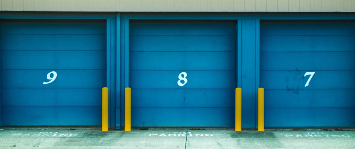 Blue and yellow storage units with descending numbers in the center of each door.