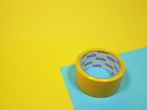 Packing tape on top of a blue and yellow background