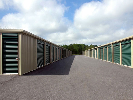 Rows of outdoor storage units with green doors