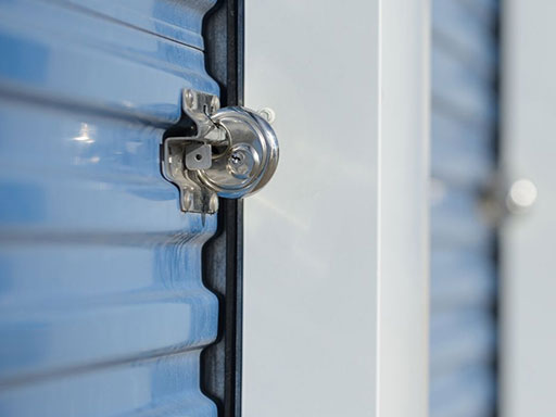 A lock on a blue storage unit door