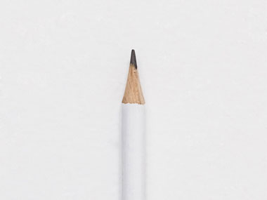Minimalist sharpened white pencil isolated on white background