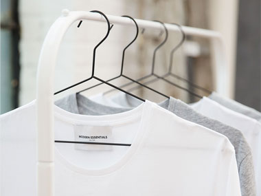 White and gray shirts on hangers showing how to live minimally