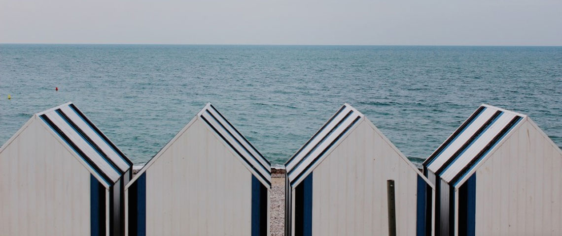 Storage spaces lined up on a beach with a tranquil background to represent minimalism