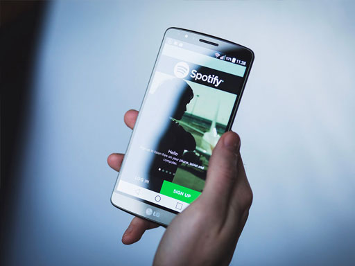Person holding phone with Spotify open